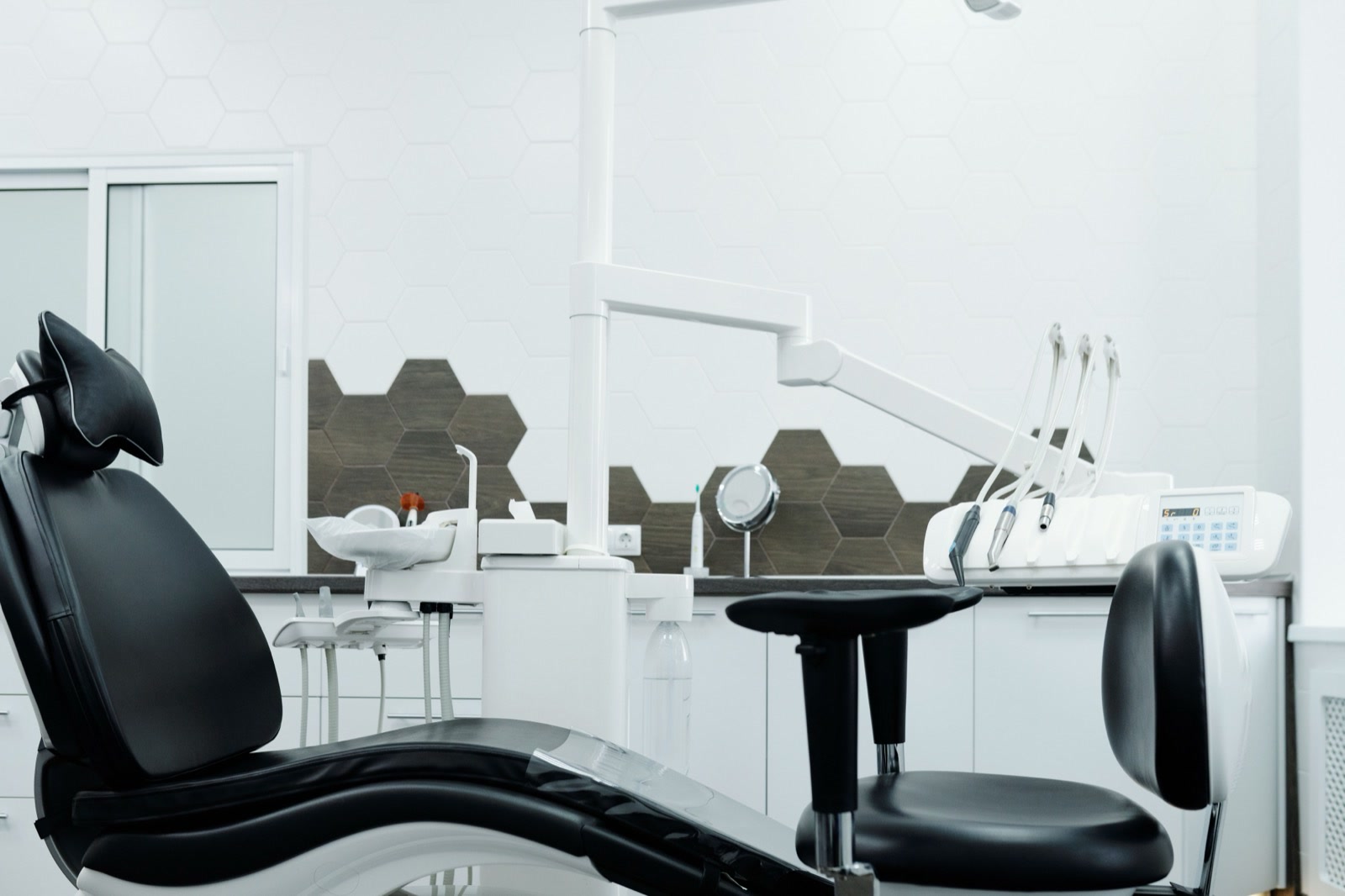 A dental chair and its instrument unit in a treatment room